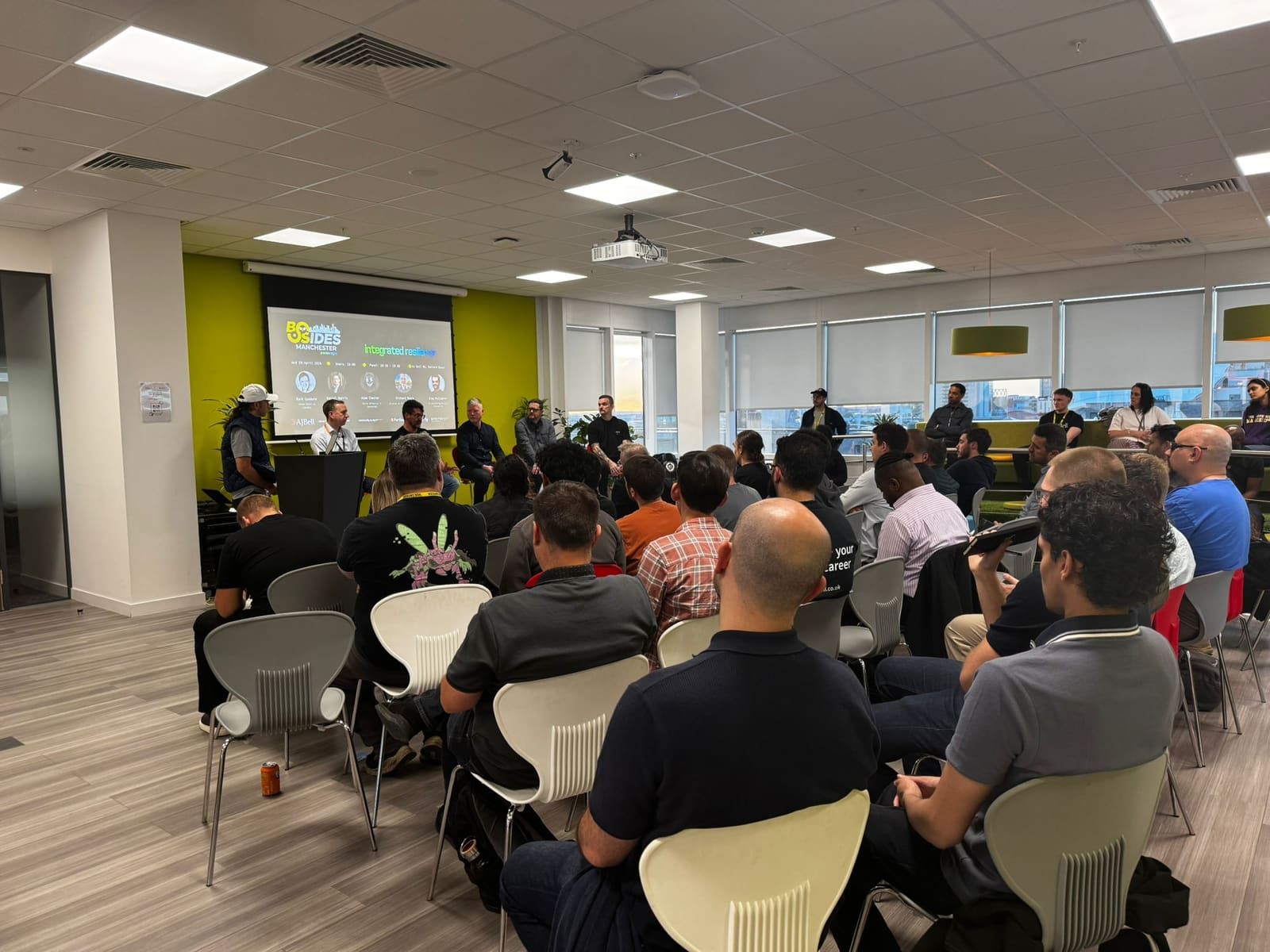 The full room during the preview night, audience seated and watching the panel