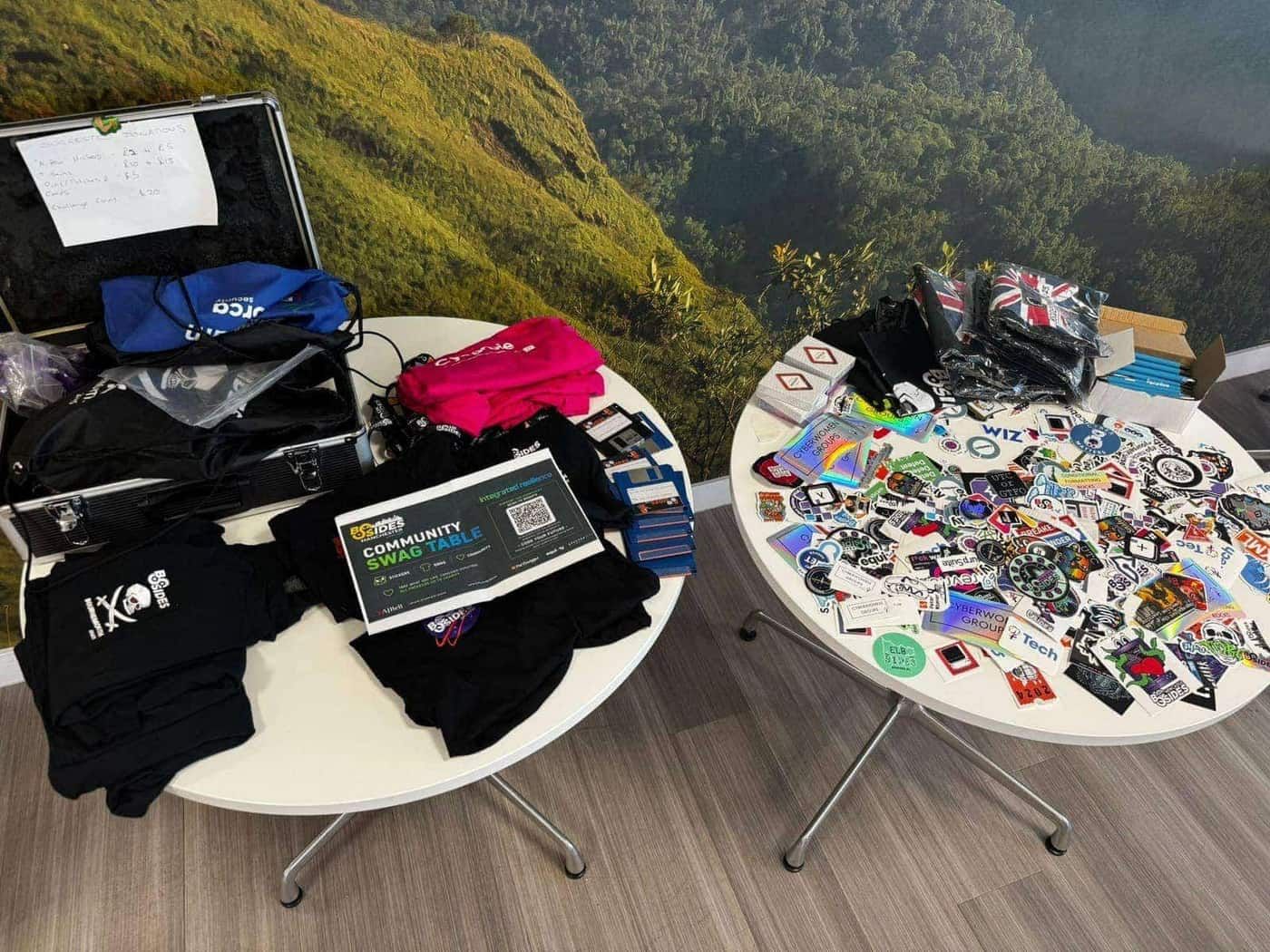 The community swag table close-up, with stickers and shirts from community sponsors